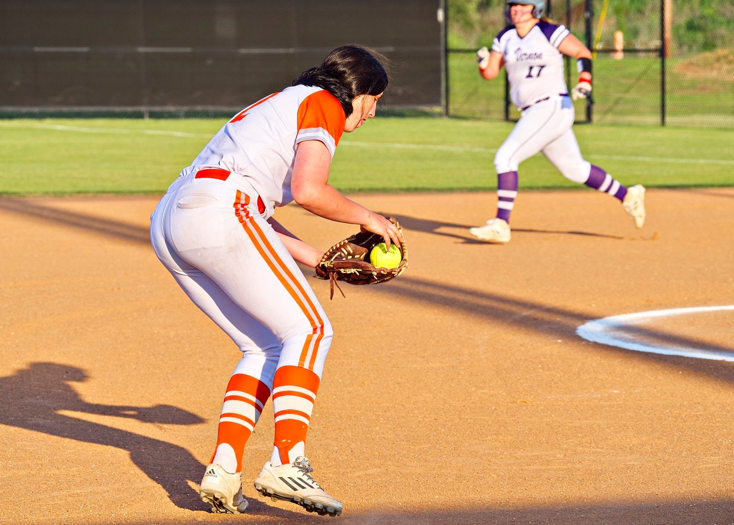 Brittany Pickle prepares to fire for an out after fielding a grounder at third. [see more senior night action]